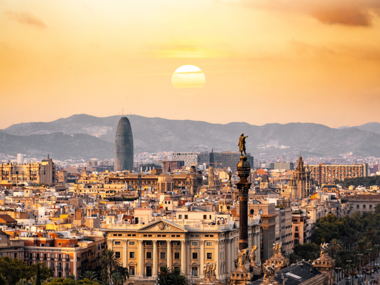 Picture of colonial city with mountain background during a sunset