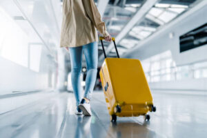 Woman dragging her suitcase through airport